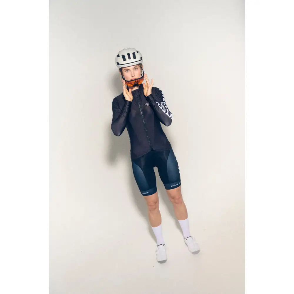 Women wearing a black cycling outfit and helmet 