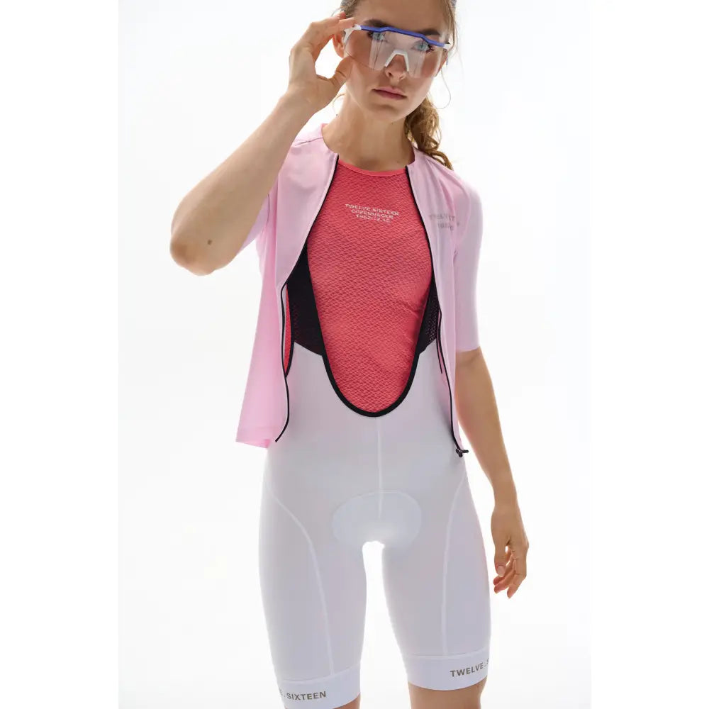 Person wearing a pink and white TwelveSixteen outfit with protective eyewear 