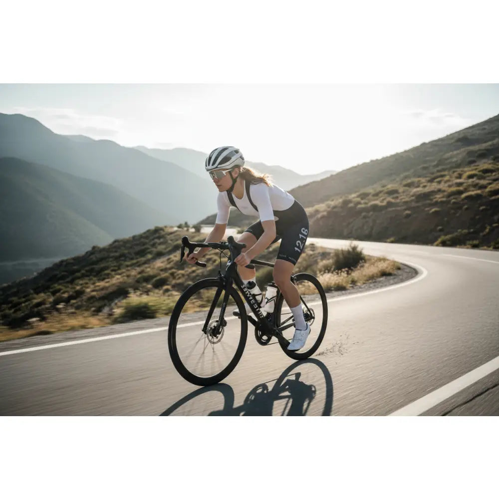 Cyclist riding on a mountain road with scenic background
